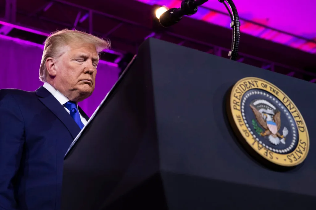 President Donald Trump bows his head down at a conservative summit in Washington. (AP Photo/Manuel Balce Ceneta)