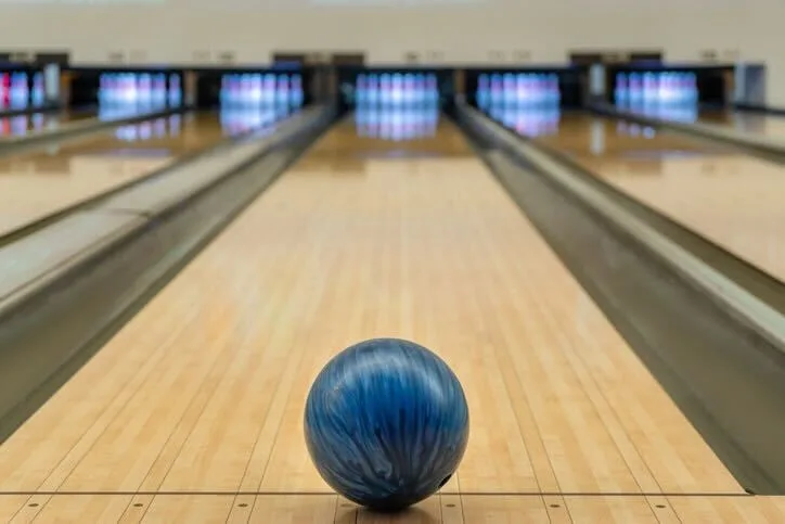 Blue bowling ball in a bowling lane.