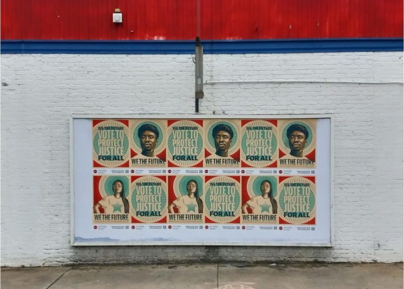 We The Future signs along a street wall.