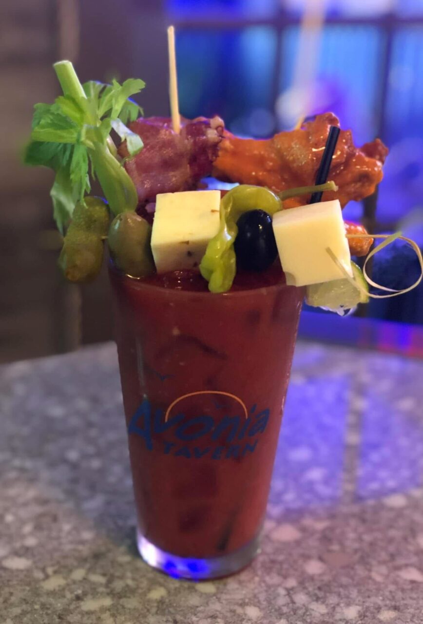 A bloody mary with a chicken wing garnish
