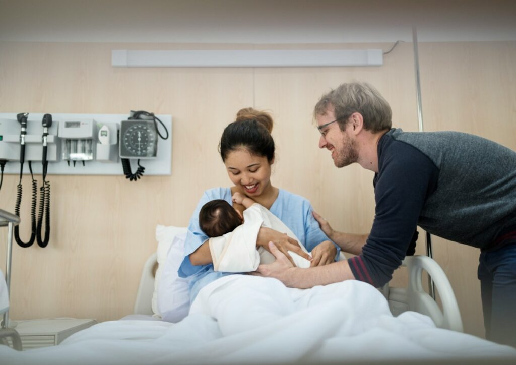 Young couple holding their newborn baby.