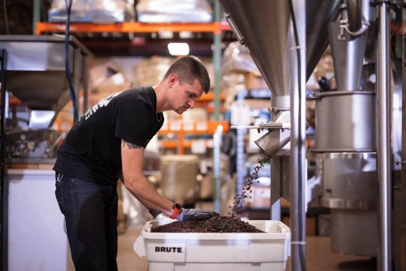 Barista works with coffee