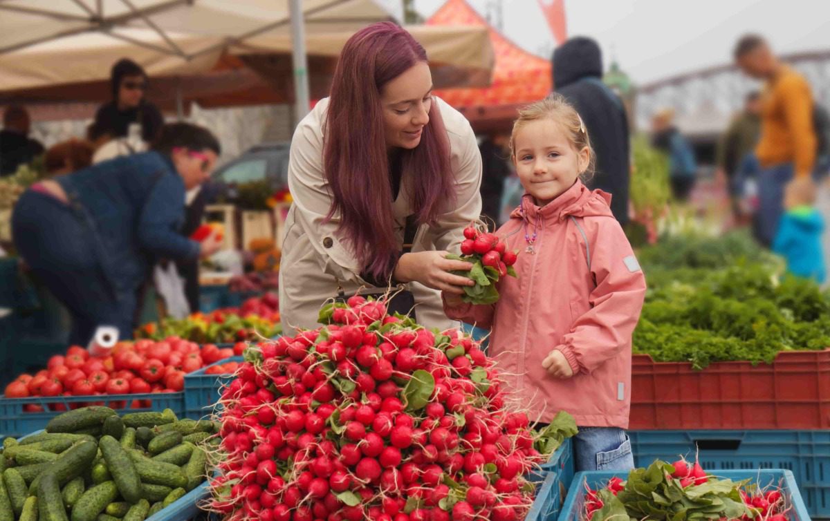 mom-and-daughter mom and daughter look at strawberries at a Pittsburgh farmers market