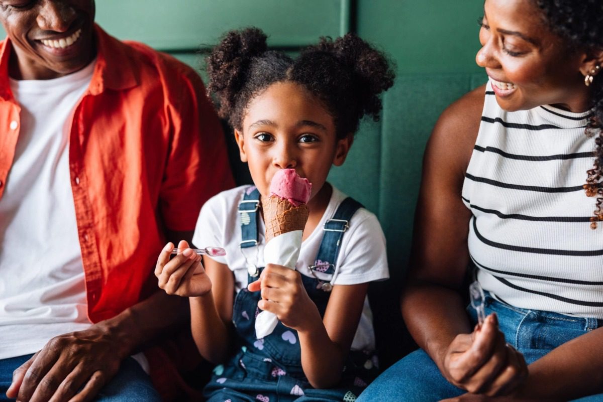 ice-cream-kid-min adorable child sits between parents holding an ice cream cone on Pennsylvania's ice cream trail.