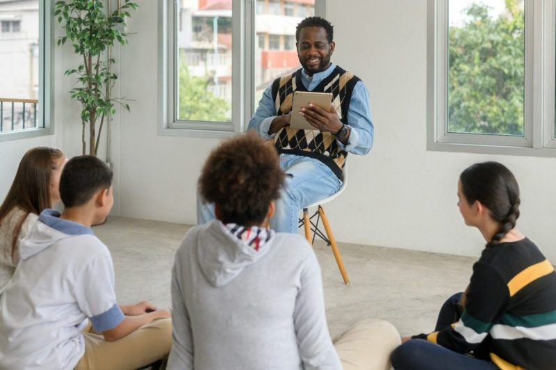 a man reads to children for juneteenth