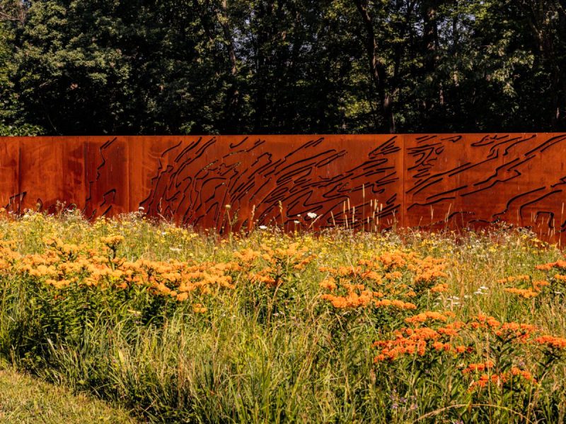 a steel art piece nestled among bright wildflowers in pennsylvania