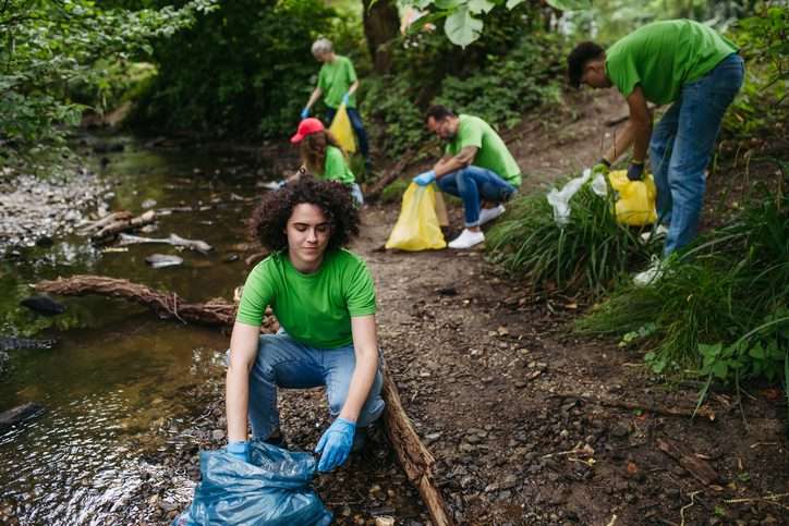 Group of volunteers during forest cleanup. Environmental education program. Earth Day concept.
