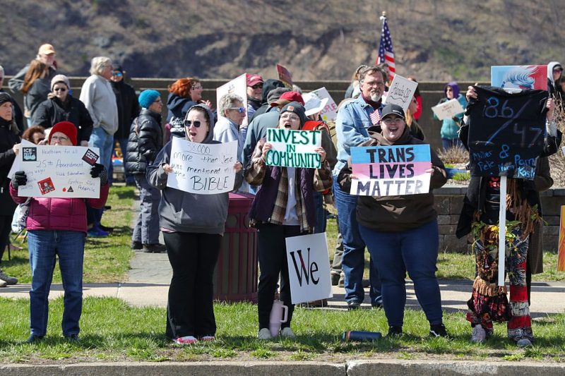 SUNBURY, PENNSYLVANIA, UNITED STATES - 2026/03/28: Protesters gathered at Riverfront Park for a "No Kings" protest against the Trump administration and its policies; participants held hand-lettered placards and American flags. Organizers said the local rally was one of more than 3,300 sister demonstrations held nationwide.