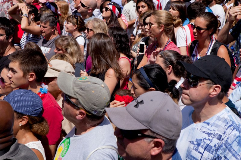 Photo of a crowd of people packed together in the heat