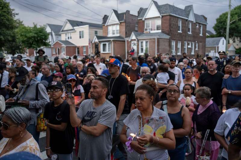 People gather for a candlelight vigil for Sgt. Angel Sarah Rampersad outside her home.