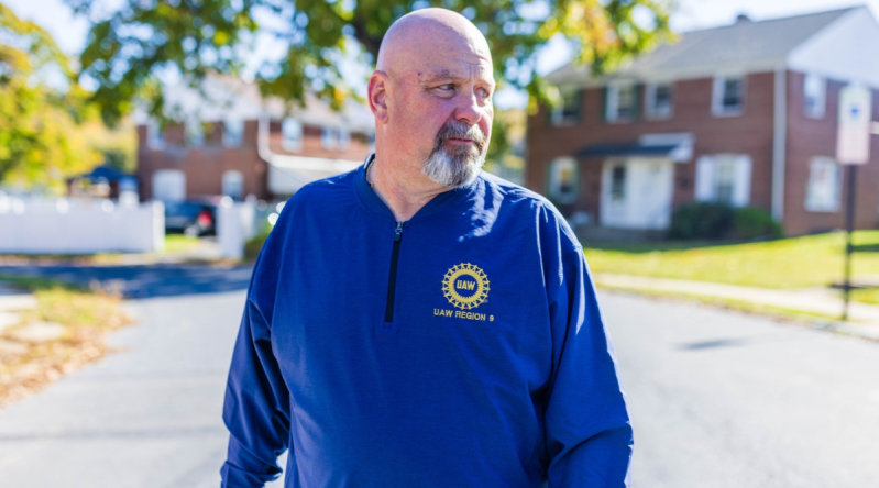Bob Brooks wearing a United Auto Workers sweater while canvassing in Allentown.