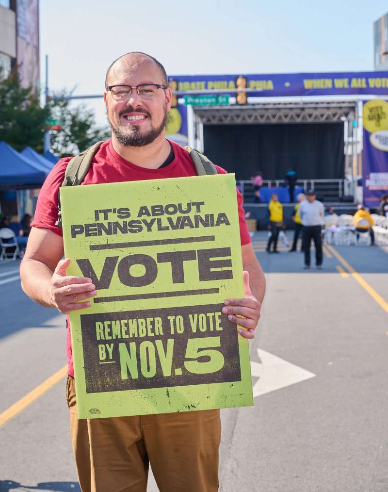A participant holds a sign during a Party at the Polls event. Party at the polls is a national initiative to fight voter suppression and support community.